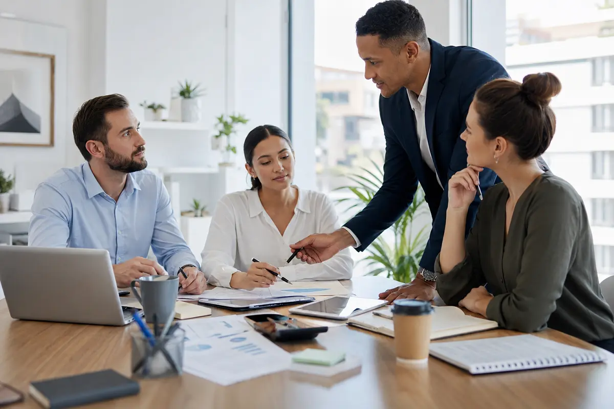 Business team engaged in a labour capacity planning meeting around a conference table